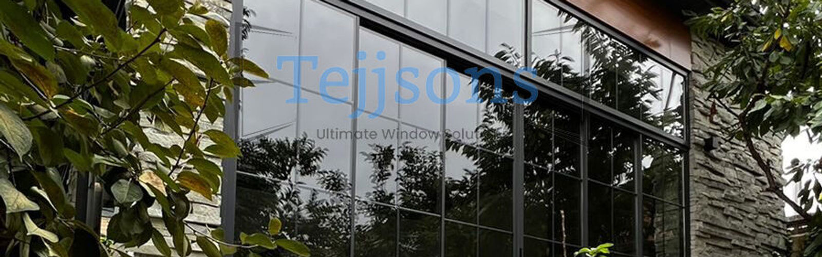 Custom aluminium window with Georgian bars installed on a modern stone facade