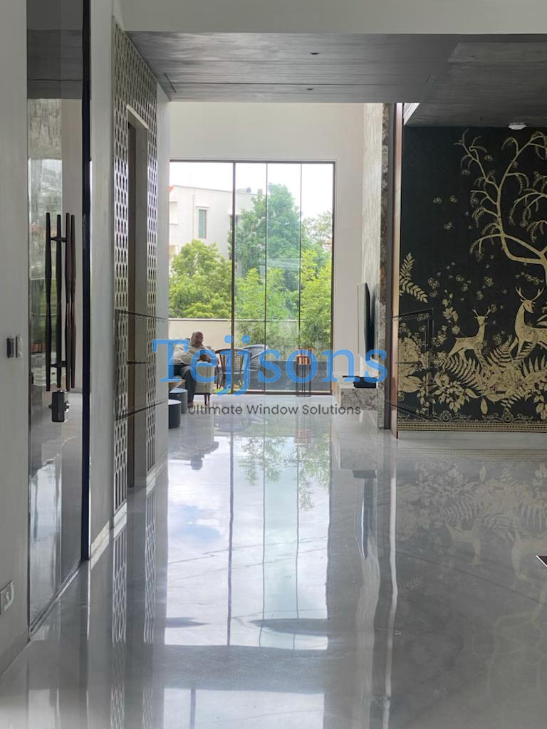 Floor-to-ceiling motorised aluminium glass window in penthouse master bedroom