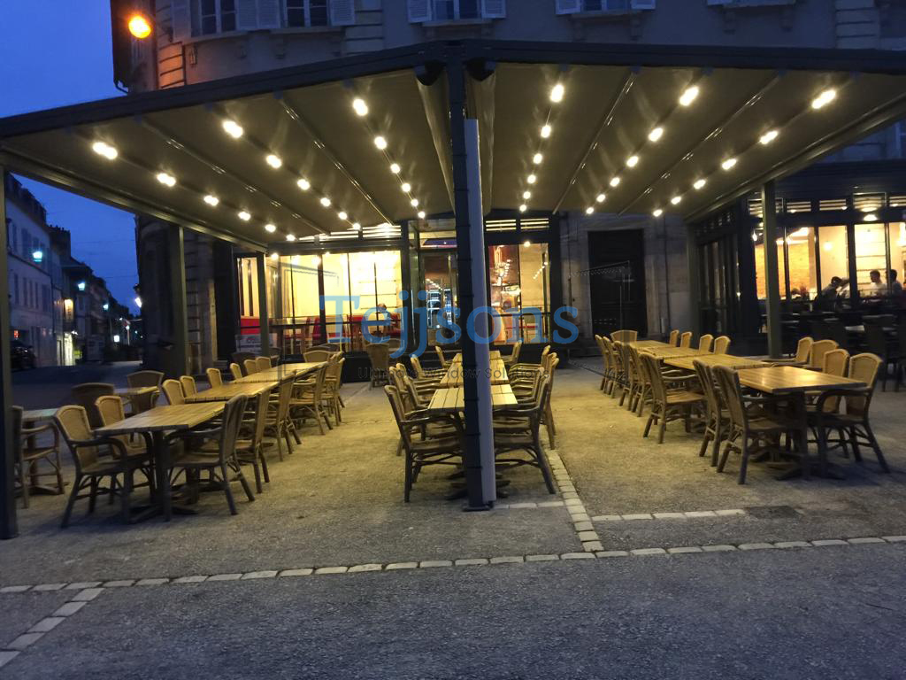 Modern pergola with integrated LED lighting over outdoor restaurant seating