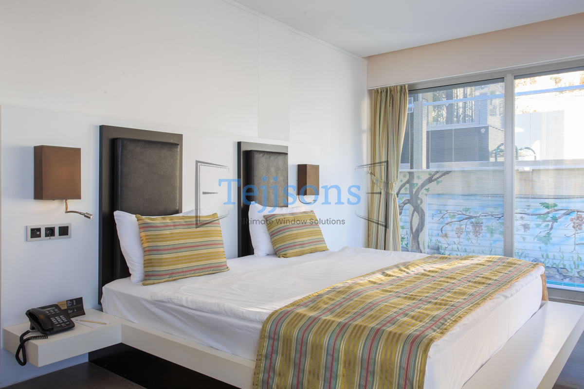 Modern bedroom featuring integral blinds window