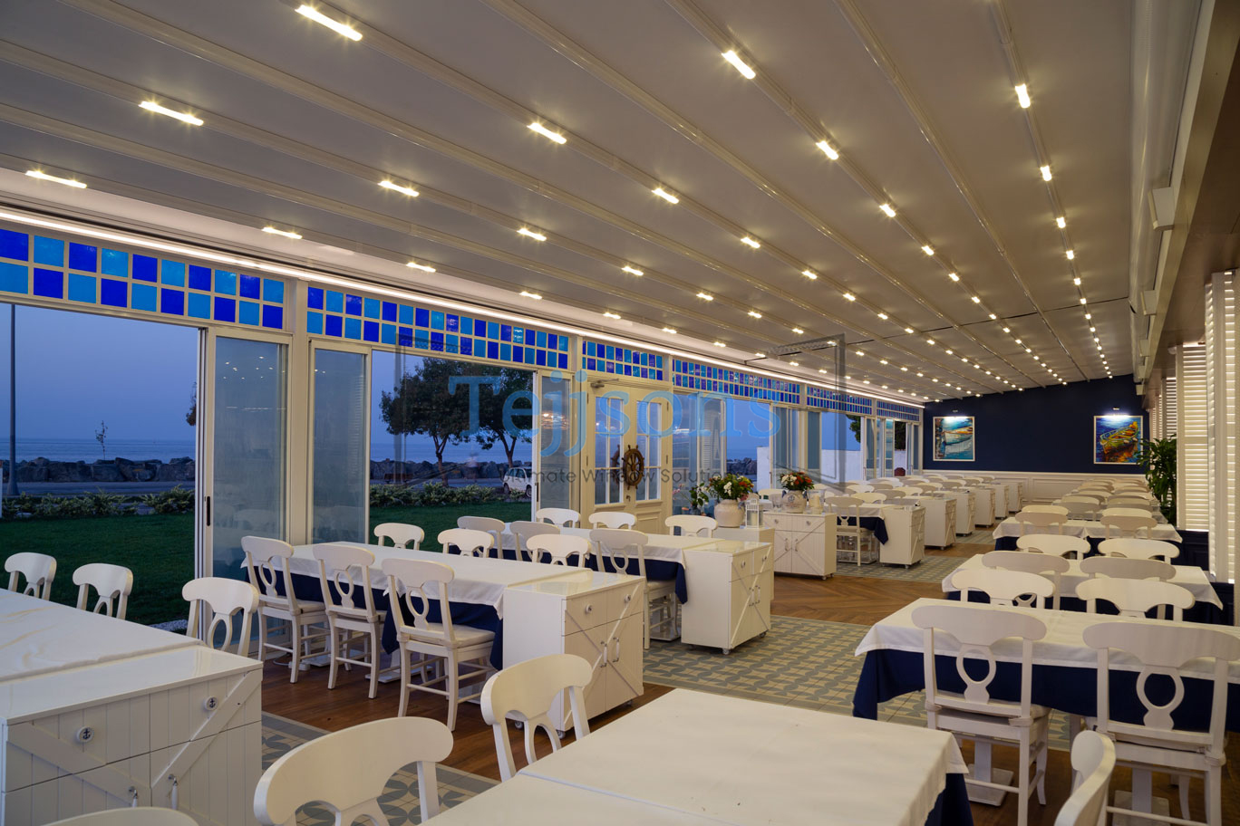 Modern restaurant pergola with retractable roof and lighting