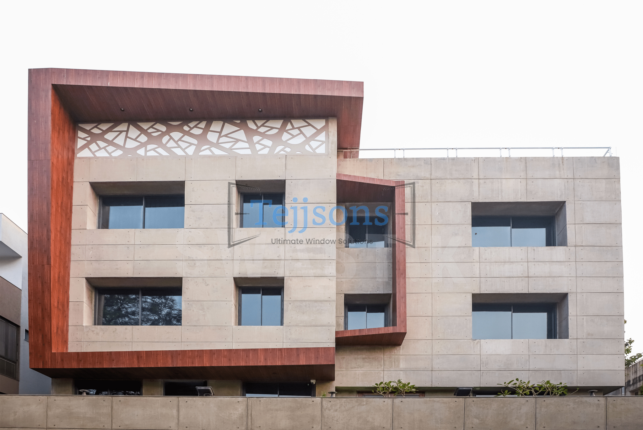 Modern building facade with stone cladding and minimal aluminium glazing