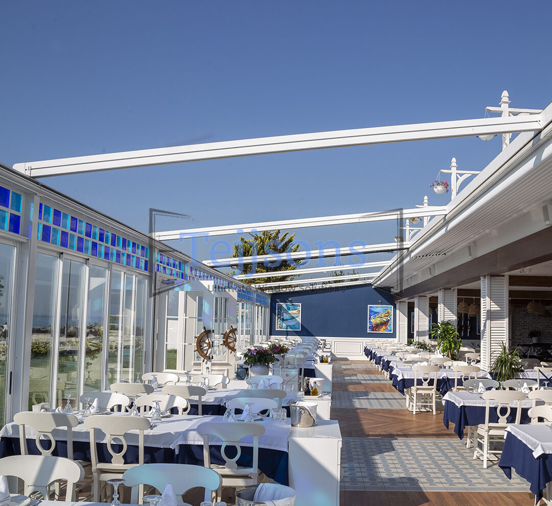 Modern white retractable aluminium pergola over outdoor patio
