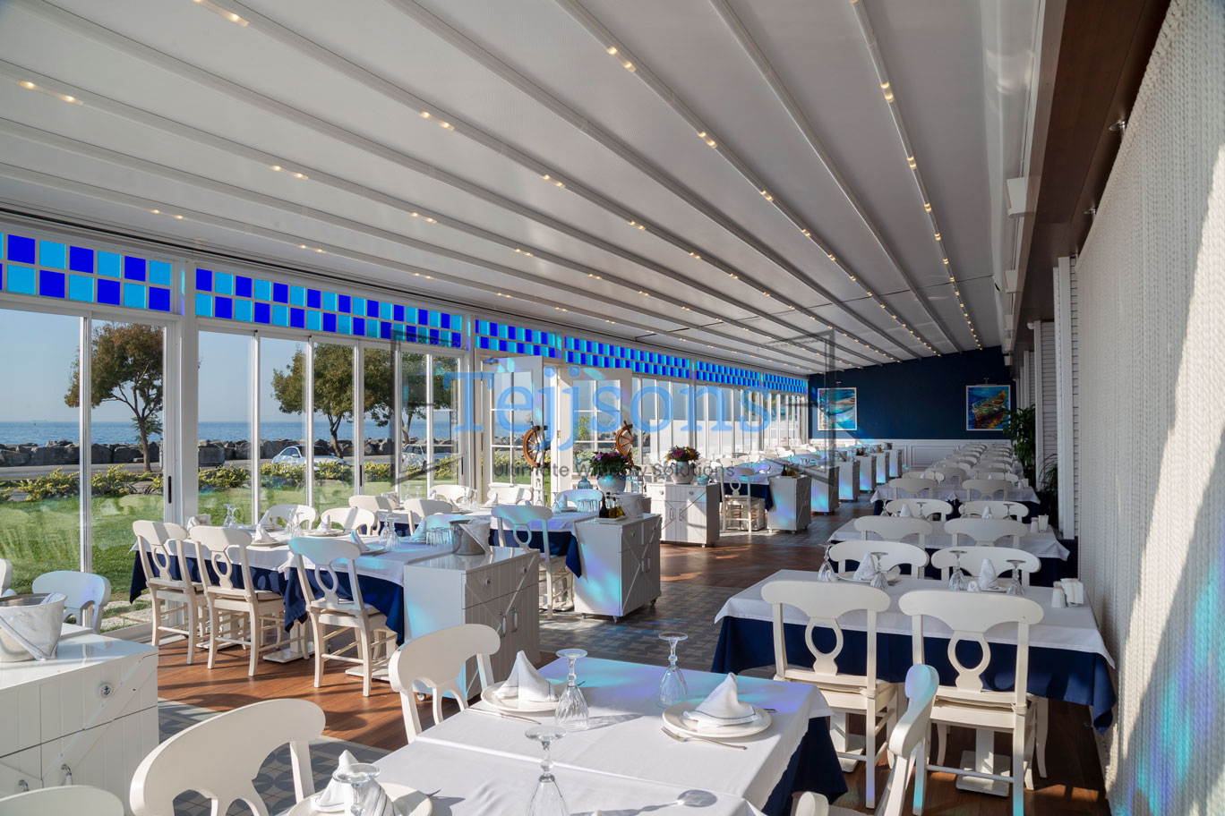 Modern pergola covering a restaurant patio with sea views