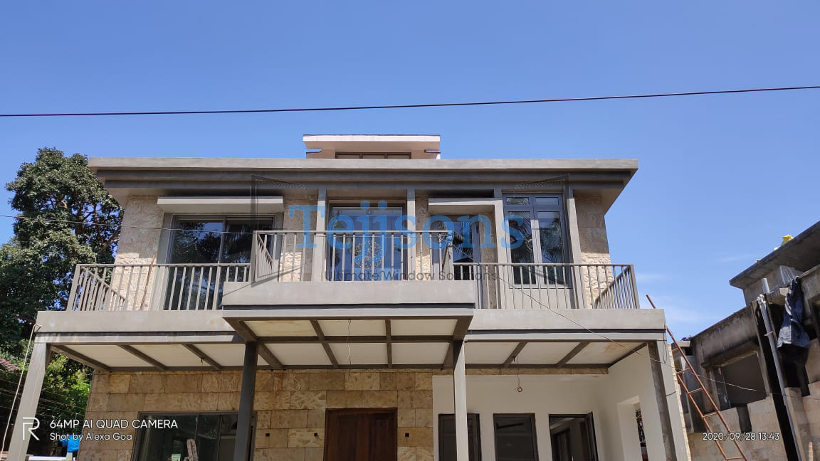 Two story luxury residence with minimal aluminium windows and balconies