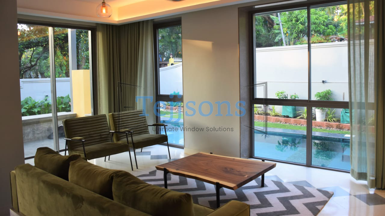 Modern villa living room with minimal windows overlooking outdoor pool